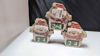 Front view showing three shrink-wrapped wooden snowmen with number blocks