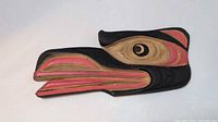 Front view of carved wood eagle/raven head