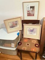 Chair with three framed prints displayed
