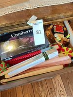 Drawer view of boxed set, candles, figurine and plastic picks
