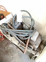 Top view showing compressor pump, motor, dual flywheel pulleys, hose