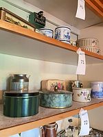 Middle shelf showing the six tins that form the lot