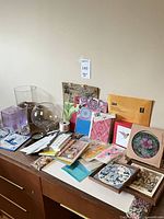 Group shot showing all glass vases, stationery, ribbon, framed tiles
