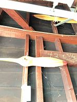 Both propellers mounted on rafters, showing size and red tips
