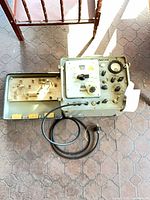 Closed metal carry case with attached power cord