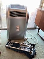 Front view of Whynter portable air conditioner with control panel and included dolly