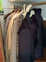 Row of women’s coats on closet rail