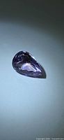 Front view of faceted pear-cut ametrine