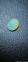 Front view of oval opal showing multicolour pinfire