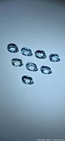 Eight oval aquamarine stones arranged on surface