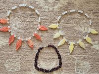 Full view of the three necklaces laid out on carpet