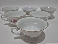 Front angled view of all six teacups showing shape, patterns and quantity
