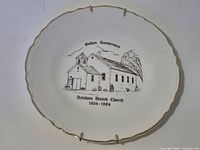Front view showing church illustration, anniversary text, gold rim