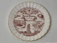 Full view of North Dakota souvenir plate showing design and gold trim