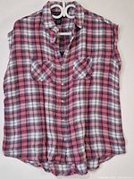 Front view of plaid sleeveless top on hanger
