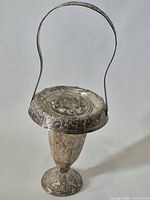 Full view of silver-plated vase with handle upright