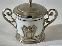 Full view of sugar bowl showing lid, handles, metal mount, spoon slot