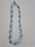 Full view of two-strand beaded necklace laid flat
