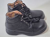 side view of both boots showing overall style, lacing, and condition