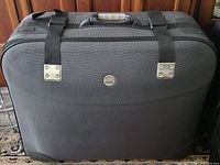 Front view of black Samsonite suitcase showing logo and straps