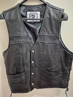 Front view of Highway 2 black leather vest on hanger