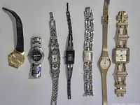 Seven watches laid out side by side for overall view