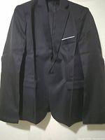 Front view of black suit jacket hanging