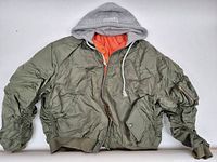 Front view of olive bomber jacket with grey hood