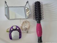 Group shot of radio, earbuds, mirror and hairbrush