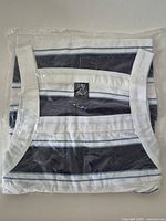 Folded striped shirt sealed in plastic