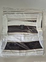 Folded striped shirt sealed in plastic packaging