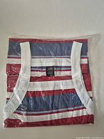 Front view of sleeveless striped cotton shift in packaging
