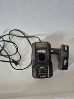 Charger and battery top view, cord visible