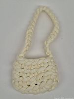 Full view of braided off-white shoulder bag