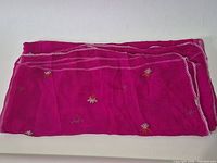 Full view of folded magenta silk scarf