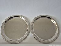 Both silver-plated platters front view