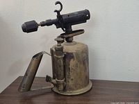Side view of entire vintage blow torch showing pump, handle, and burner
