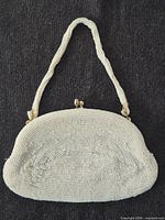 Front view of micro-beaded purse showing shape and strap