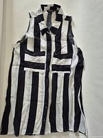 Full view of sleeveless striped blouse showing collar, buttons, pockets