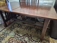 Full view of dining table showing top, base, and surrounding area