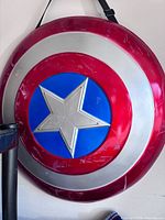 Full view of large plastic Captain America shield hanging