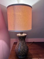 Full view of lamp showing wood base and fabric drum shade