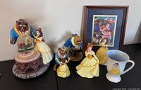 Group shot showing all items: snow globe, additional figurines, framed print, mug
