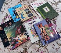 Group shot of all nine Disney hardcover books on floral surface