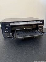 Front view of Epson XP-640 with output tray extended showing SD slot and USB port