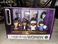 Front view of Inspiring Women boxed set showing four figures and box graphics