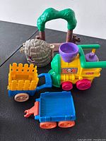 Train engine, two cars, tree arch, boulder cave