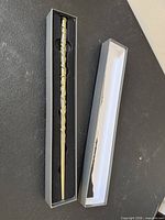 Wand inside open presentation box