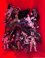 Top view of red bin showing mixed Star Wars action figures and accessories