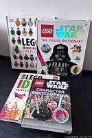 Front covers of four LEGO DK hardcover books displayed upright and stacked